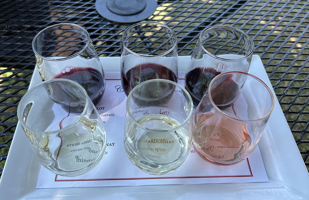 A flight of six wines in glasses