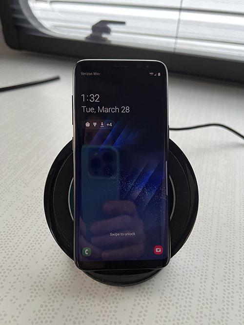 Samsung phone in a charging cradle
