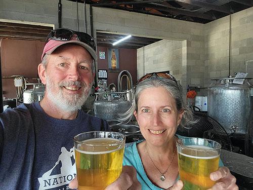 Tracy and Vic holding beers at High Springs Brewery