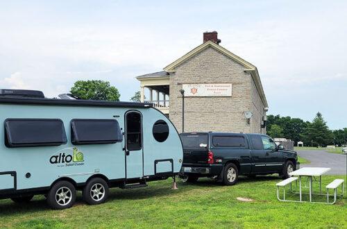 Alto Travel Trailer parked in front of stone building