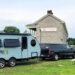 Alto Travel Trailer parked in front of stone building