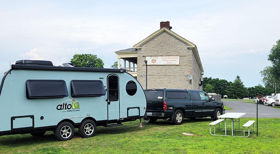 Alto Travel Trailer parked in front of stone building